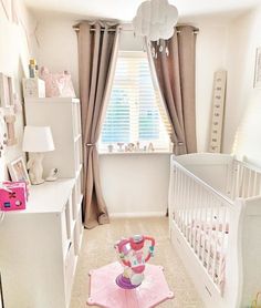 a baby's room with pink and white decor