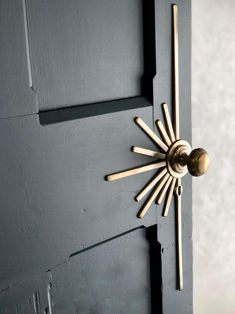 the door handle is made out of wood and has a sunburst design on it