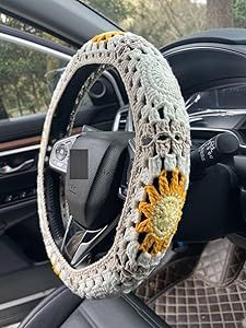 the interior of a car with a steering wheel cover made out of crochet