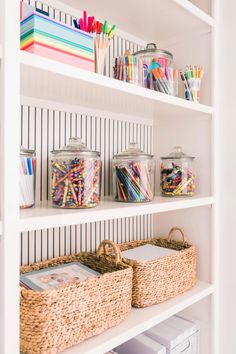 the shelves are organized with baskets and pencils