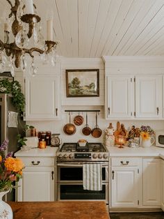 a kitchen with white cabinets and an old fashioned stove