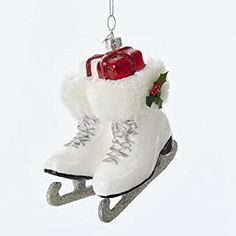 a pair of white snow boots hanging from a christmas ornament