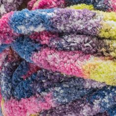 multicolored crocheted blanket laying on top of each other in close up