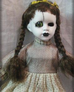 a doll with long hair wearing a dress