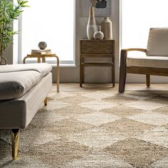 a living room scene with focus on the couch and chair, coffee table and vases