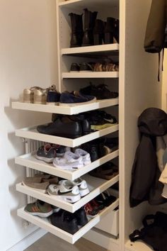 a closet with several shelves and shoes on the bottom shelf in front of it,