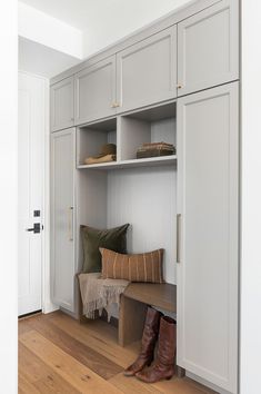 a wooden bench sitting inside of a white closet