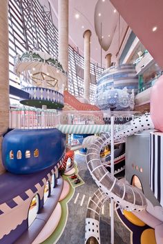 an indoor play area with slides and toys