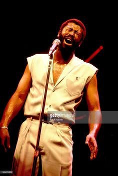 a man singing into a microphone on stage