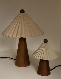 two wooden lamps sitting next to each other on a table