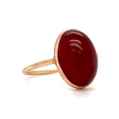 This stylish Victorian Bezel Set Carnelian Cocktail Ring features a cabochon cut red carnelian in polished 14 karat yellow gold. The center gemstone showcases a warm, crimson red hue. Set in a bezel on a dainty band. Perfect for signet ring & statement ring lovers. Timeless and chic. This antique cocktail ring would make a great gift for any loved one! Formal Red Carnelian Ring, Red Domed Gemstone Rings, Classic Red Ruby Ring With Oval Cabochon, Carnelian Cabochon Ring As Gift, Carnelian Yellow Gold Rings With Oval Cabochon, Yellow Gold Oval Cabochon Carnelian Rings, Red Ruby Oval Cabochon Ring In 14k Gold, Oval Cabochon Red Ruby Ring In 14k Gold, Red Oval Cabochon Ring With Polished Finish