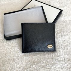 Very Unique Bifold Men’s Wallet From Gucci Featuring Glass Finish Leather And Brand Plaquet Logo Luxe Calf Leather W/ Smooth Finish Classic Black Front Plaquet Logo With Silver/Gold Details Bifold Closure 8 Individual Card Slots 2 Bill Compartments 2 Side Slots Formal Black Wallets With Engraved Logo, Designer Gucci Wallet With Logo Plaque, Designer Wallets With Engraved Logo For Professional Use, Designer Business Wallets With Engraved Logo, Luxury Gucci Wallets With Logo Plaque, Designer Black Wallet With Engraved Logo, Black Wallets With Logo Plaque For Everyday Use, Designer Black Wallets With Engraved Logo, Black Business Wallet With Logo Plaque