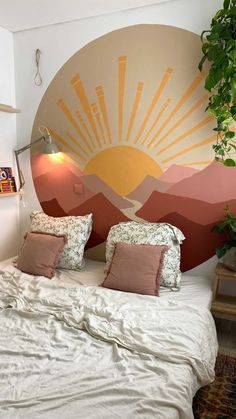 a bed with two pillows on top of it next to a wall mounted planter