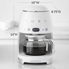 a white coffee maker sitting on top of a counter