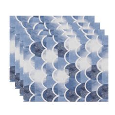 six blue and white paper napkins with wavy shapes