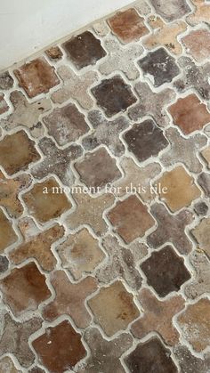 a tile floor with brown and tan colors