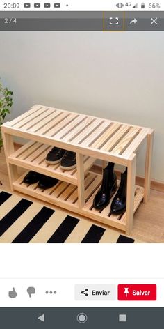 a wooden shoe rack with two pairs of black shoes on it and a striped rug