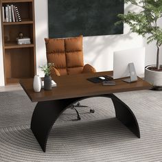 an office desk with a laptop on it in front of a bookshelf and potted plant