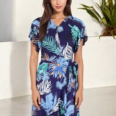 Elevate your summer wardrobe with the Anna-Kaci Women's Tropical Print High-Low Wrap Dress. This eye-catching dress features a vibrant tropical print that exudes island vibes, perfect for warm-weather adventures. The wrap design offers a flattering fit, accentuated by a waist tie that cinches beautifully at the waist. Flutter sleeves add a touch of femininity, while the high-low hemline provides a playful yet elegant silhouette. Whether you're headed to a beachside brunch or a casual day out, th Casual Flutter Sleeve Dress For Vacation, Summer Beach Maxi Dress With Flutter Sleeves, Summer Vacation Midi Dress With Flutter Sleeves, Blue Tropical Print Midi Dress For Summer, Blue Summer Midi Dress With Tropical Print, Flowy Tropical Short Sleeve Dress, Flowy Short Sleeve Tropical Dress, Casual Blue Tropical Print Dresses, Blue Flutter Sleeve Beach Dress