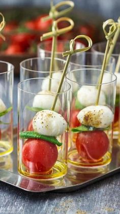 small glasses filled with mozzarella and cherry tomatoes