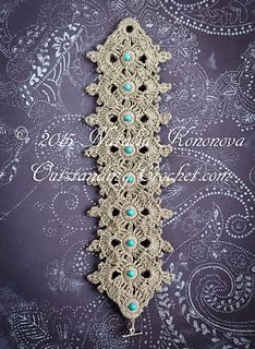 a crocheted lace with turquoise beads on the end and an intricate design in the middle