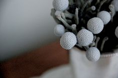 a vase filled with lots of white balls