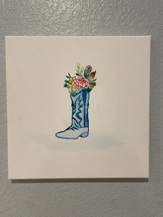 a watercolor painting of a boot with flowers in it on a white wall background