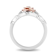 a white gold ring with an orange flower on the top and two diamonds in the middle