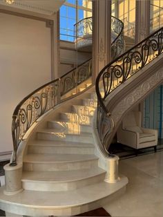 a white staircase with wrought iron handrails