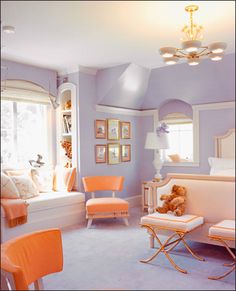 a bedroom with purple walls and orange chairs