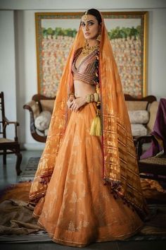 Kesaria orange striped lehenga with handblock foil print, embellished with hand embroidery and fringing. - Aza Fashions Traditional Drape Orange Sharara With Sheer Dupatta, Orange Sharara With Sheer Dupatta For Navratri, Traditional Orange Sharara With Sheer Dupatta, Bohemian Orange Sets For Festive Occasions, Bohemian Orange Festive Sets, Festive Bohemian Orange Sets, Orange Raw Silk Sharara With Pallu, Orange Anarkali Choli In Chanderi Fabric, Orange Sets With Sheer Dupatta For Navratri