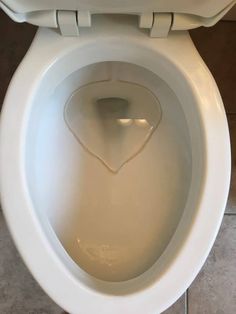 an open toilet bowl with the lid up