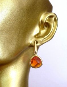 Beautiful Orange and 16k Gold Earrings Small dangle earrings on gold post Almost 1 inches  long.  If you have any questions, please feel free to message us!  All monitors display color differently; please takes this into consideration when placing your order If this is a gift and you need a note, please add so in the "notes" section when checking out. Gold Long Drop Crystal Earrings, Gold Long Drop Pierced Crystal Earrings, Orange Drop Earrings For Anniversary, Gold Teardrop Crystal Earrings For Gift, Formal Single Yellow Gold Crystal Earring, Orange Teardrop Earrings For Formal Occasions, Formal Orange Teardrop Earrings, Elegant Orange Hoop Earrings As Gift, Elegant Orange Hoop Earrings For Gift