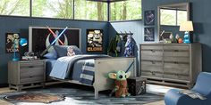 a child's bedroom decorated in star wars theme with blue walls and grey furniture