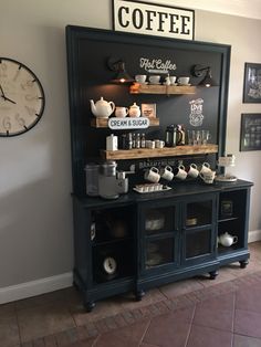 a coffee shop with lots of items on the counter and clock in the wall behind it