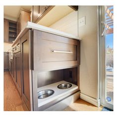 an oven built into the side of a wall in a kitchen next to a window