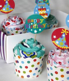 cupcakes decorated with colorful decorations and happy birthday signs