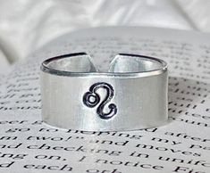 "3/8\"W Aluminum - great quality! Note - Please choose your Zodiac sign and Ring size (4 - 11 1/2) before proceeding to checkout. If you would like to personalize the ring on the inside please add under personalization. This ring is adjustable in size. Super in style!" Rings Hand, Hand Stamped Metal, Zodiac Rings, Stamped Metal, Secret Messages, Aries Zodiac, Metal Ring, Letters And Numbers, Stackable Rings