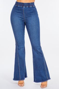 a woman in high waisted jeans is posing for the camera with her hands on her hips