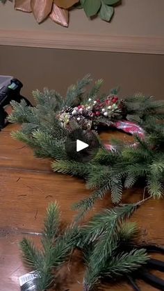 a camera is sitting on top of a table with christmas wreaths and other decorations