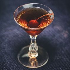 a glass filled with liquid sitting on top of a table