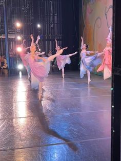 the dancers are performing on stage in their pink dresses and tutu skirted skirts