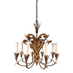 an antique chandelier with five candles hanging from it