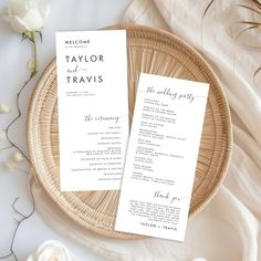 two wedding programs sitting on top of a wicker basket next to a white rose