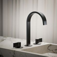 a black faucet sitting on top of a white counter