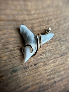 a piece of jewelry sitting on top of a wooden table