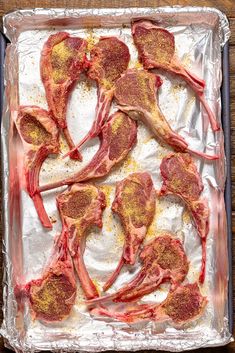 raw meat on tin foil with seasonings and spices