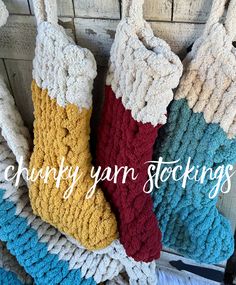 three crocheted stocking hanging on a wooden wall with the words chunk yarn stockings