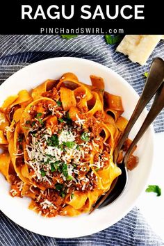 a white bowl filled with pasta sauce and topped with parmesan cheese on top