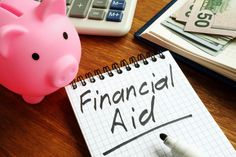 a piggy bank sitting on top of a desk next to a calculator